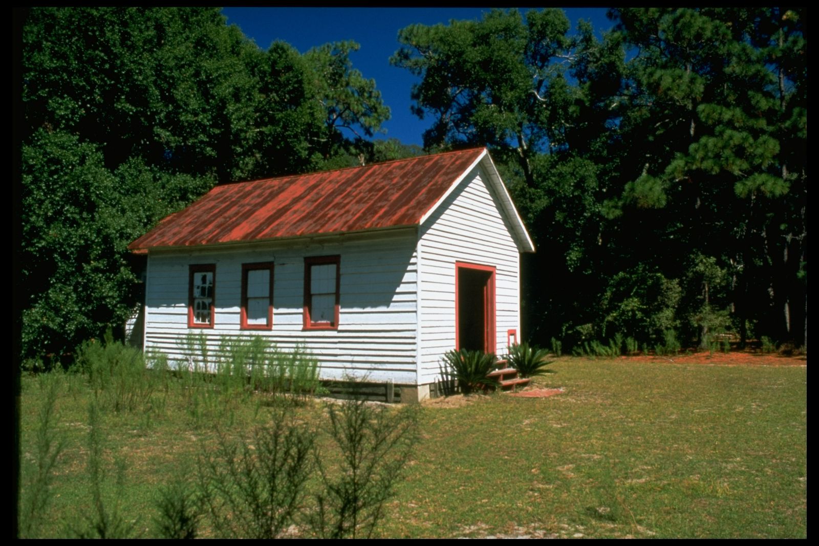 Image may contain building, outdoor, shelter, cabin, house, grass, plant, countryside and cabin