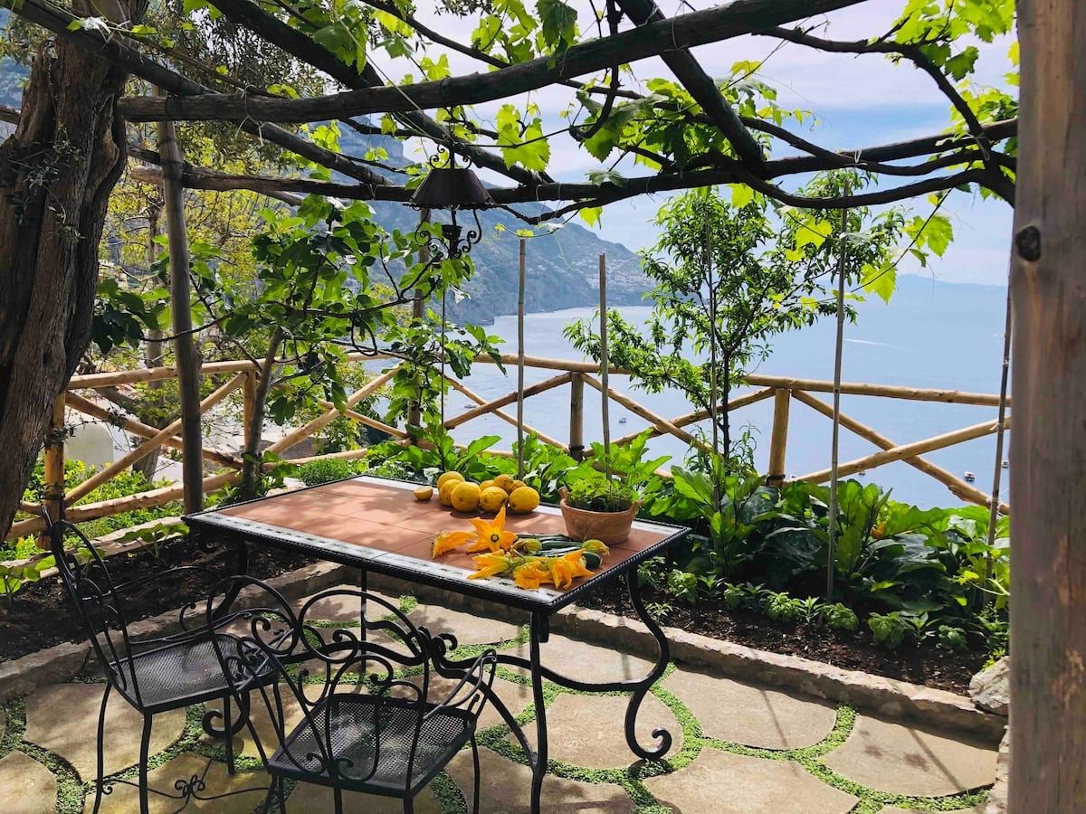 Image may contain nature, outdoor, landscape, desk, furniture, tables and chairs, plants and garden