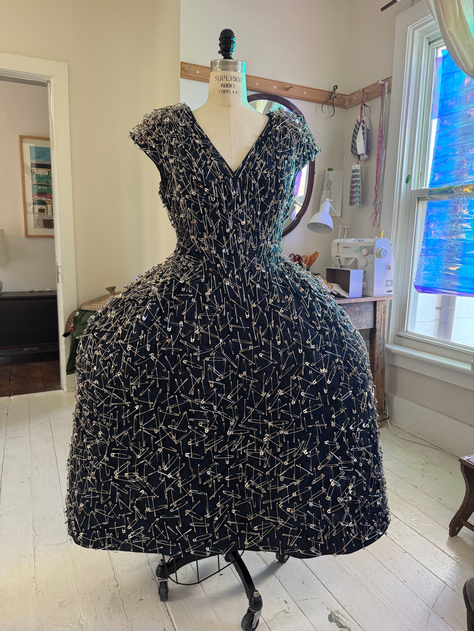 Image may contain clothing, gown, evening gown, formal wear, adult, furniture and indoor