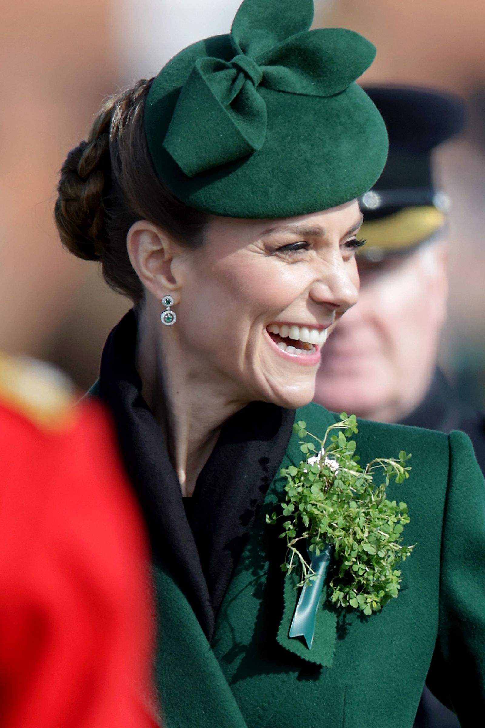 Image may contain head human face happy laughing adult smiling clothing and hat