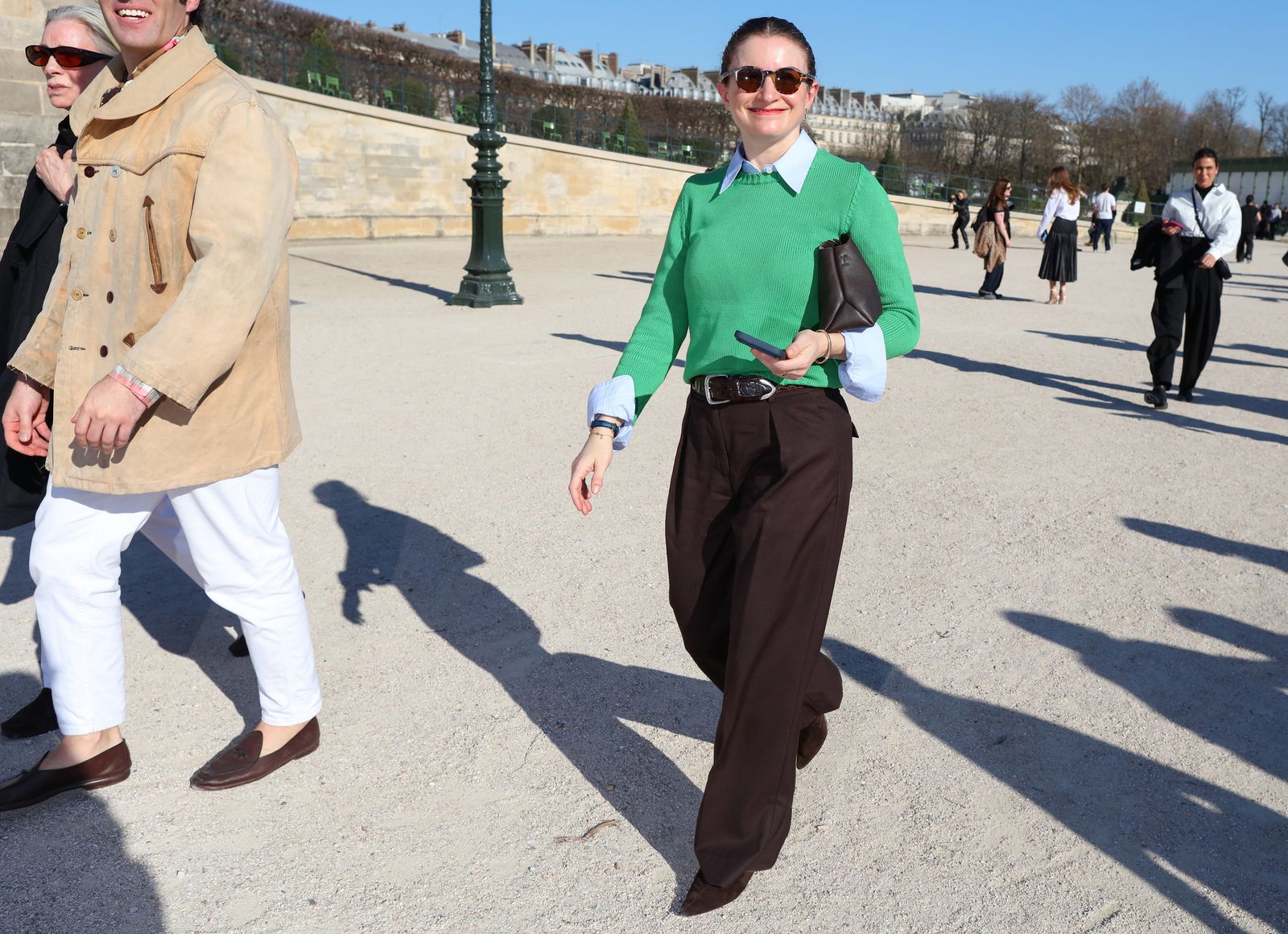 Image may contain clothing, pants, people walking, formal wear, accessories, ties, sunglasses, faces, heads and photography