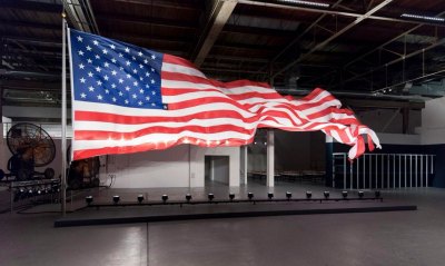 A high-powered fan inside the door fluttered a large American flag.