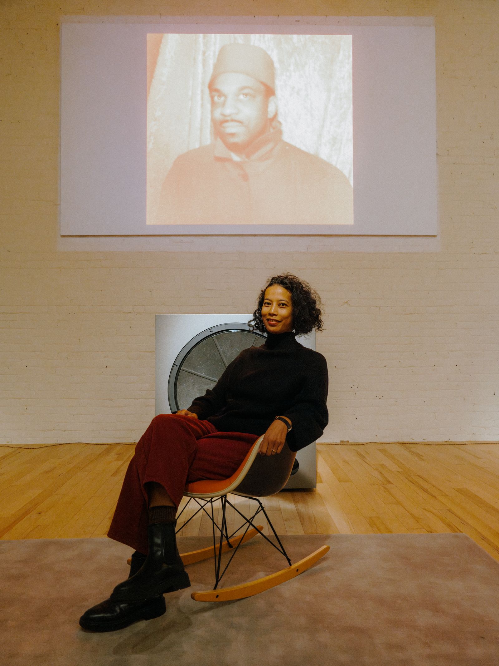 Image may contain Sun Ra Angel Aquino people sitting furniture adult face head clothing shoes