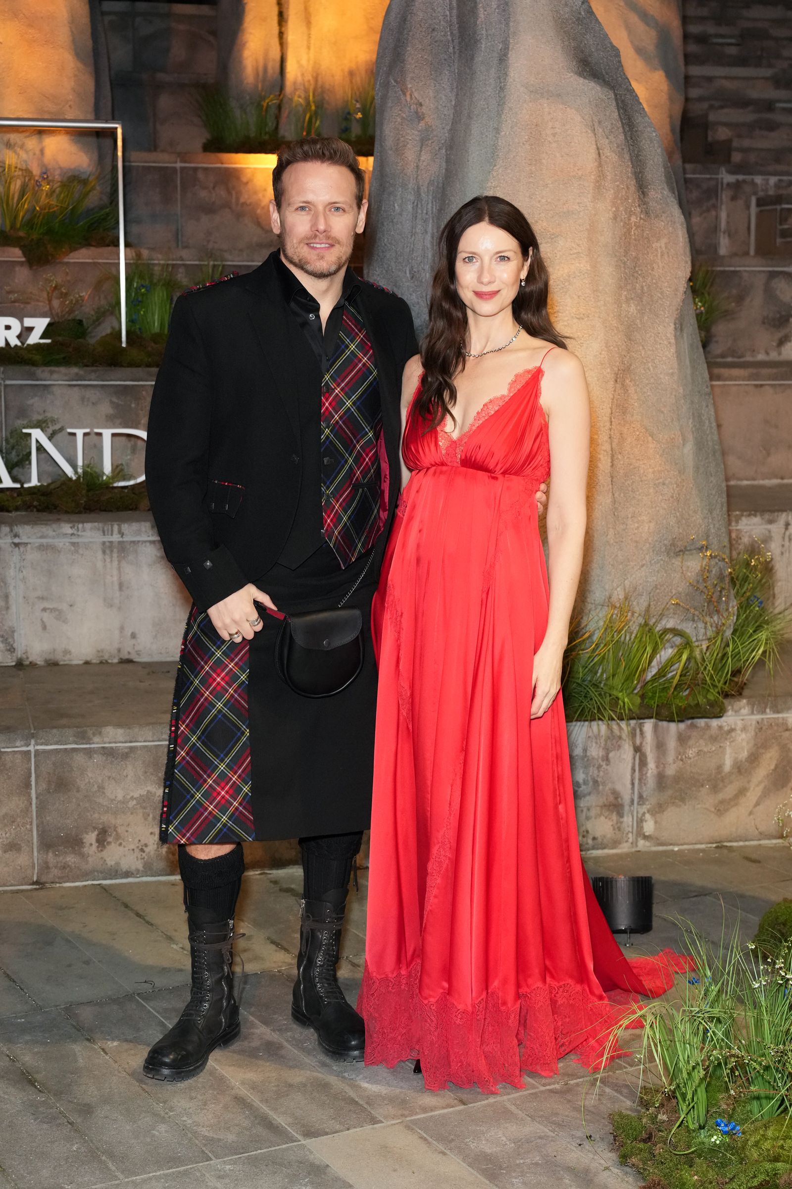 Image may contain Ben Price Caitriona Balfe clothing, skirt, tartan, adult, coat, face and head