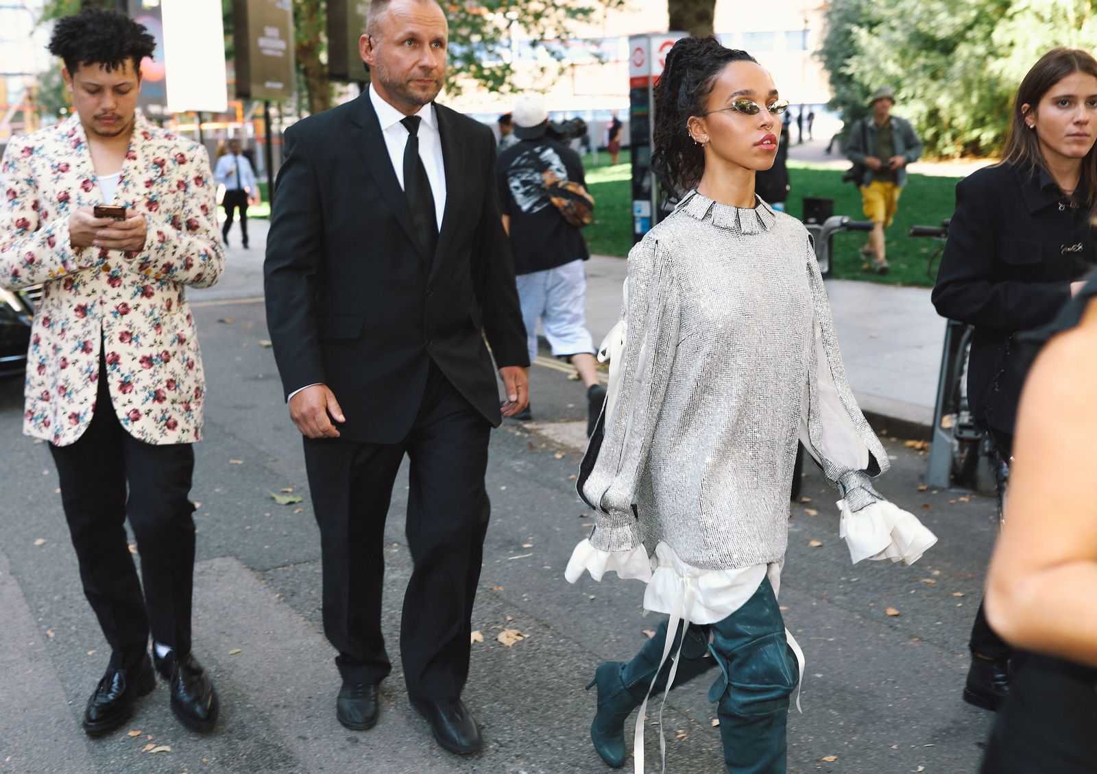 Image may contain clothing, shoes, footwear, apparel, people, ties, accessories, sunglasses and sleeves