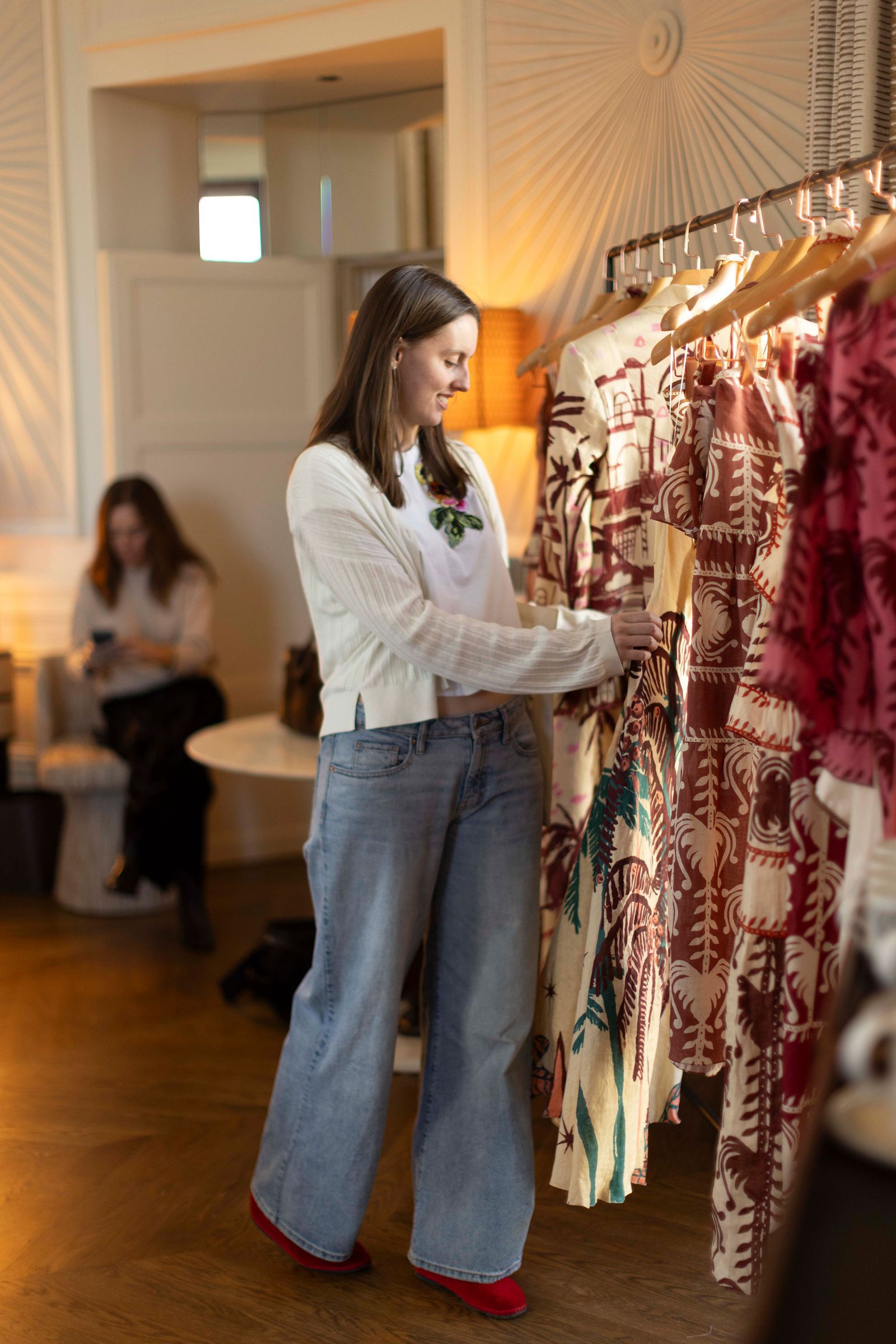 Image may contain clothing, pants, adult, jeans, locker room, indoor, furniture, face and head