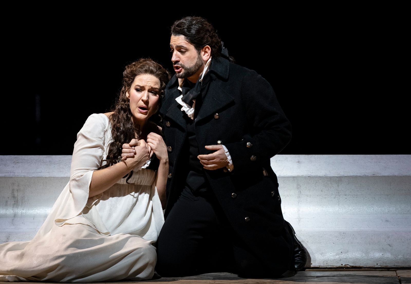 Image may contain clothing, coats, adult faces, head shots, portraits, coats, blazers and dancing