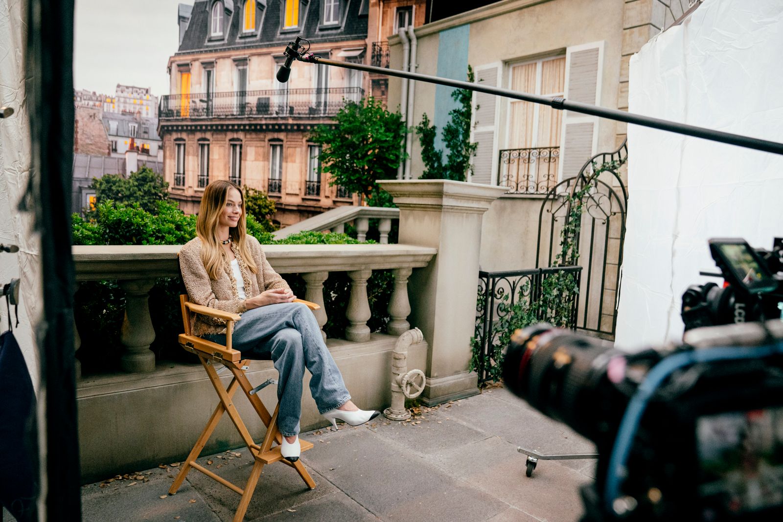 Image may contain Margot Robbie seated teen clothing shoes high heels camera and electronics