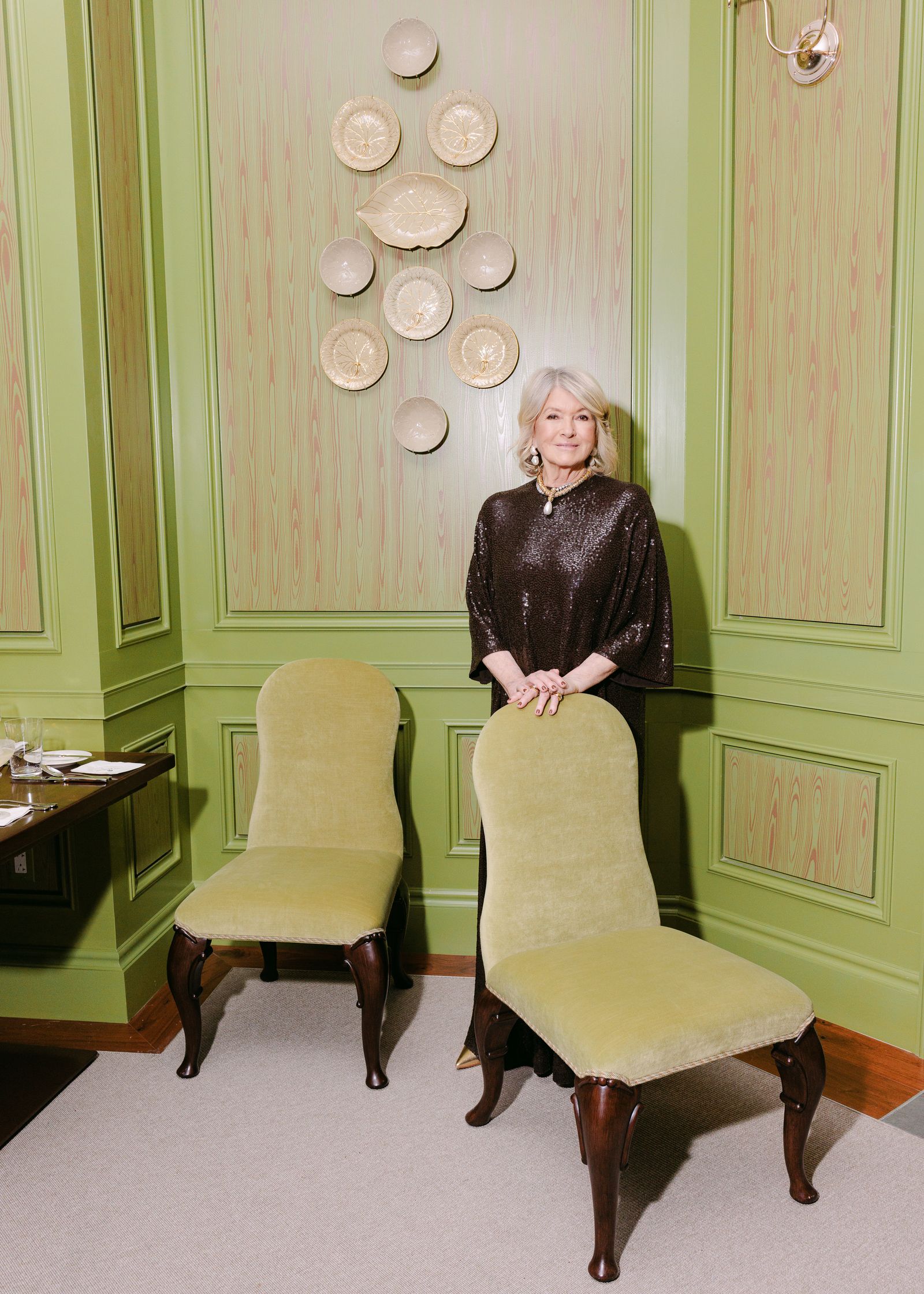 Image may contain Martha Stewart adult furniture, chairs, lounge accessories, jewelry, necklaces and plates