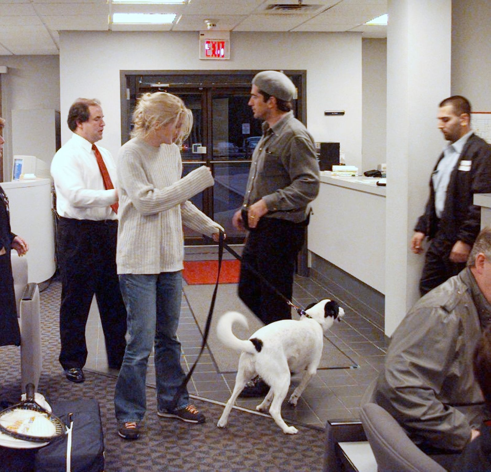 Image may contain John F. Kennedy Jr. adults, clothing, pants, accessories, straps, animals, canines and mammals