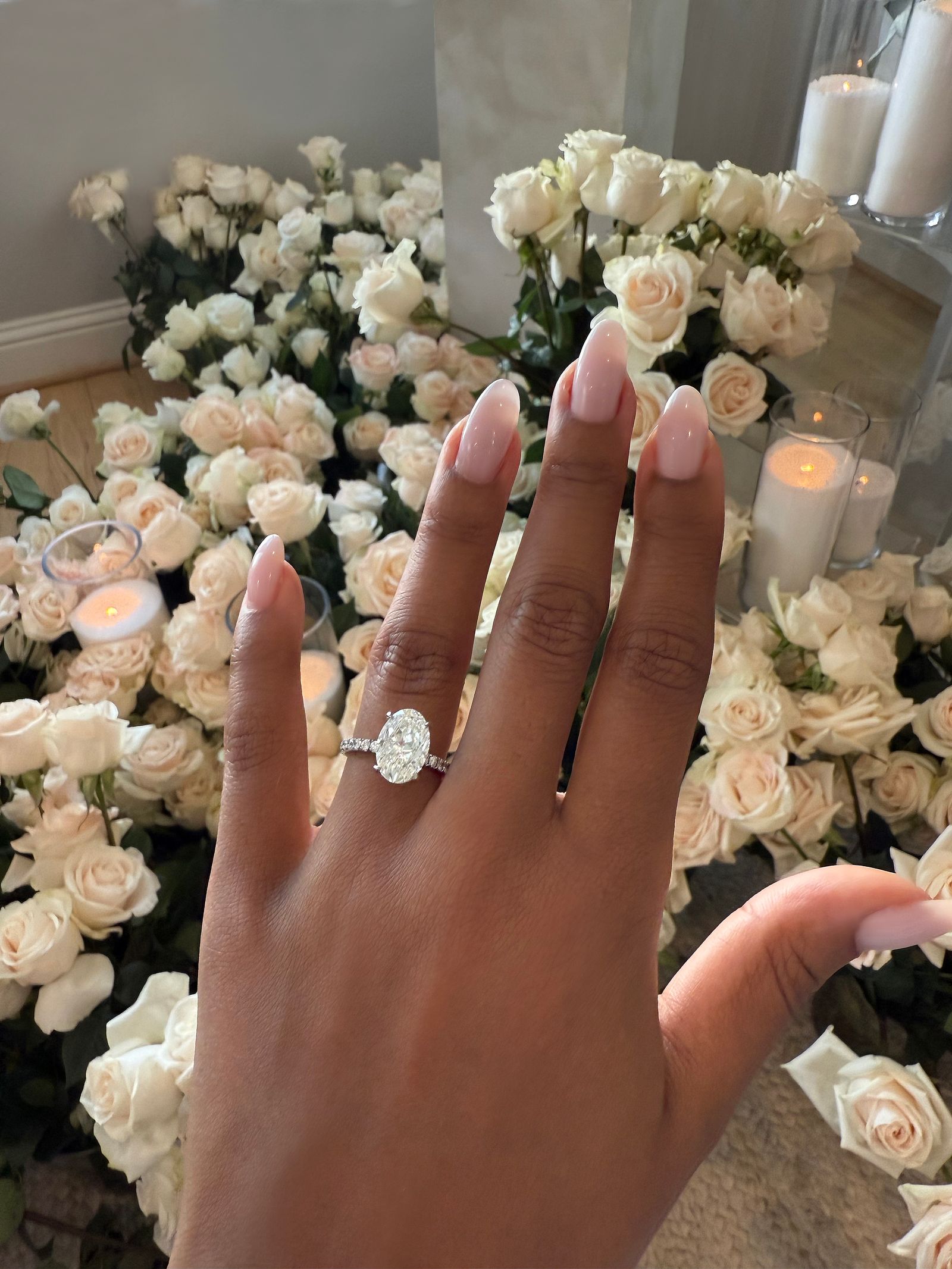 Image may contain body parts, fingers, hands, people, flowers, plants, roses, accessories, diamonds, gemstone jewelry and candles