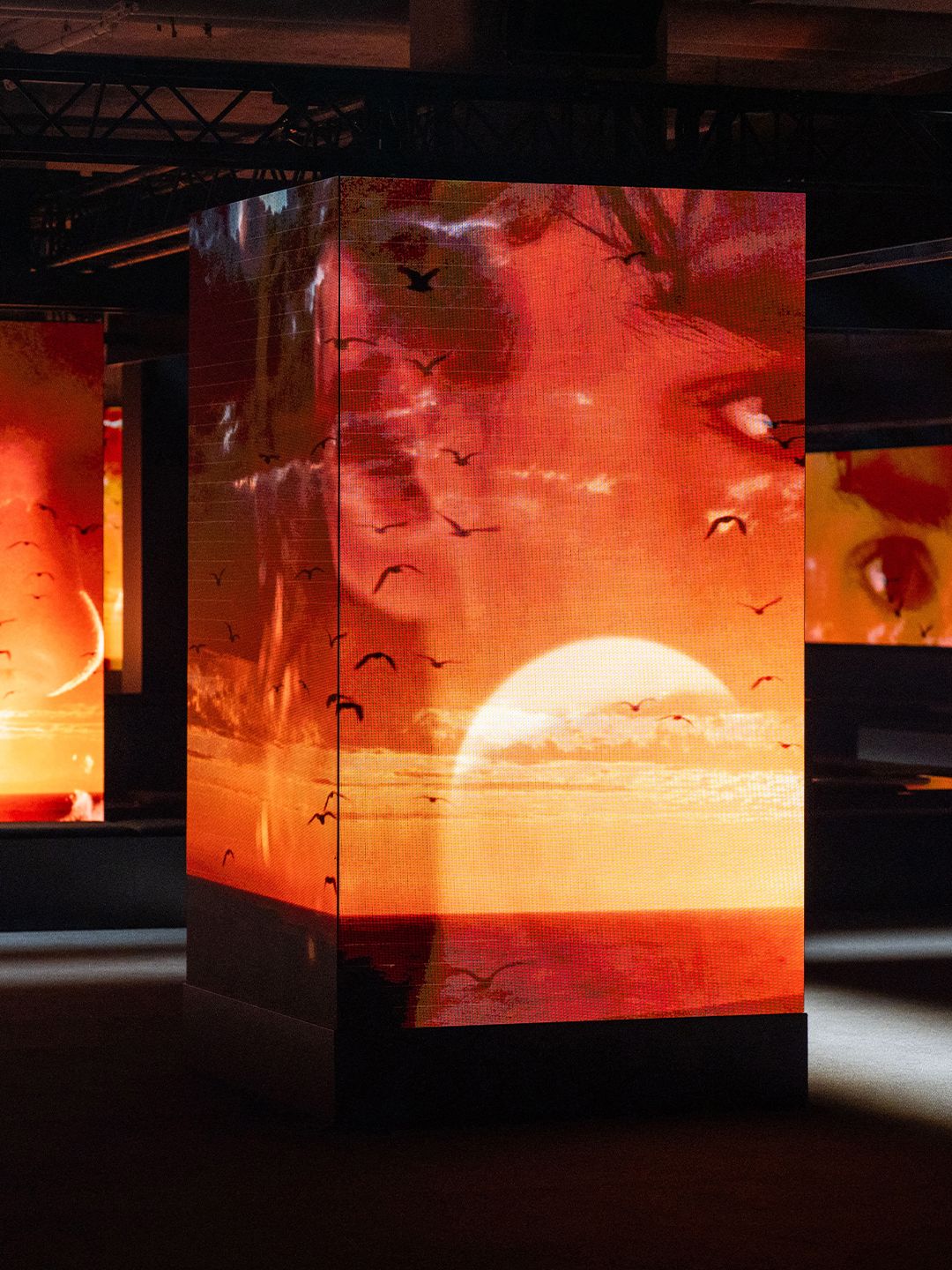 Image may contain art, modern art, electronic screens, adult wedding faces, heads and lights