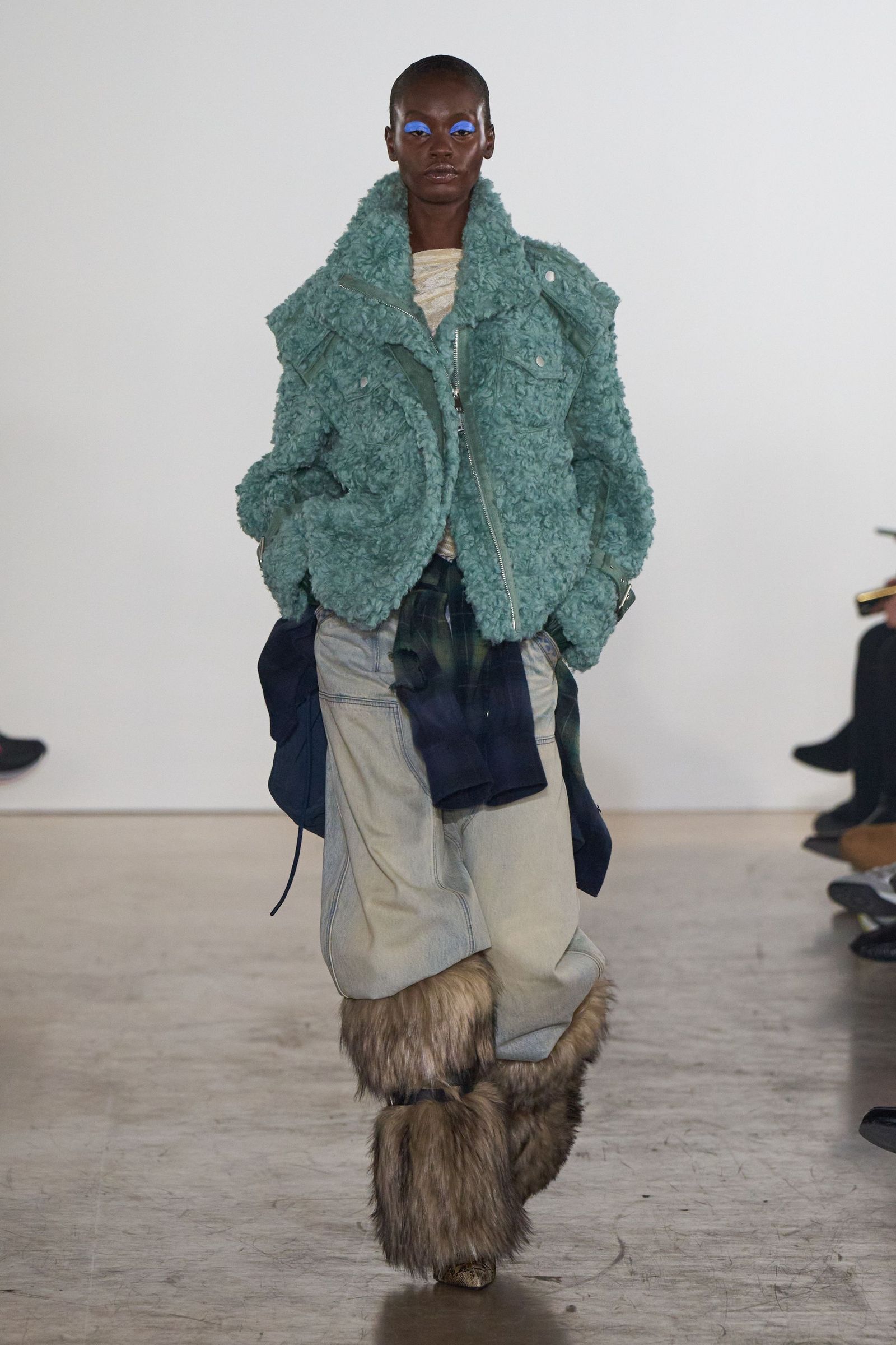 Image may contain clothing, coats, jackets, adult pants, blazers, long sleeves, fur, footwear and shoes