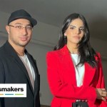 A man and a woman walk side by side.