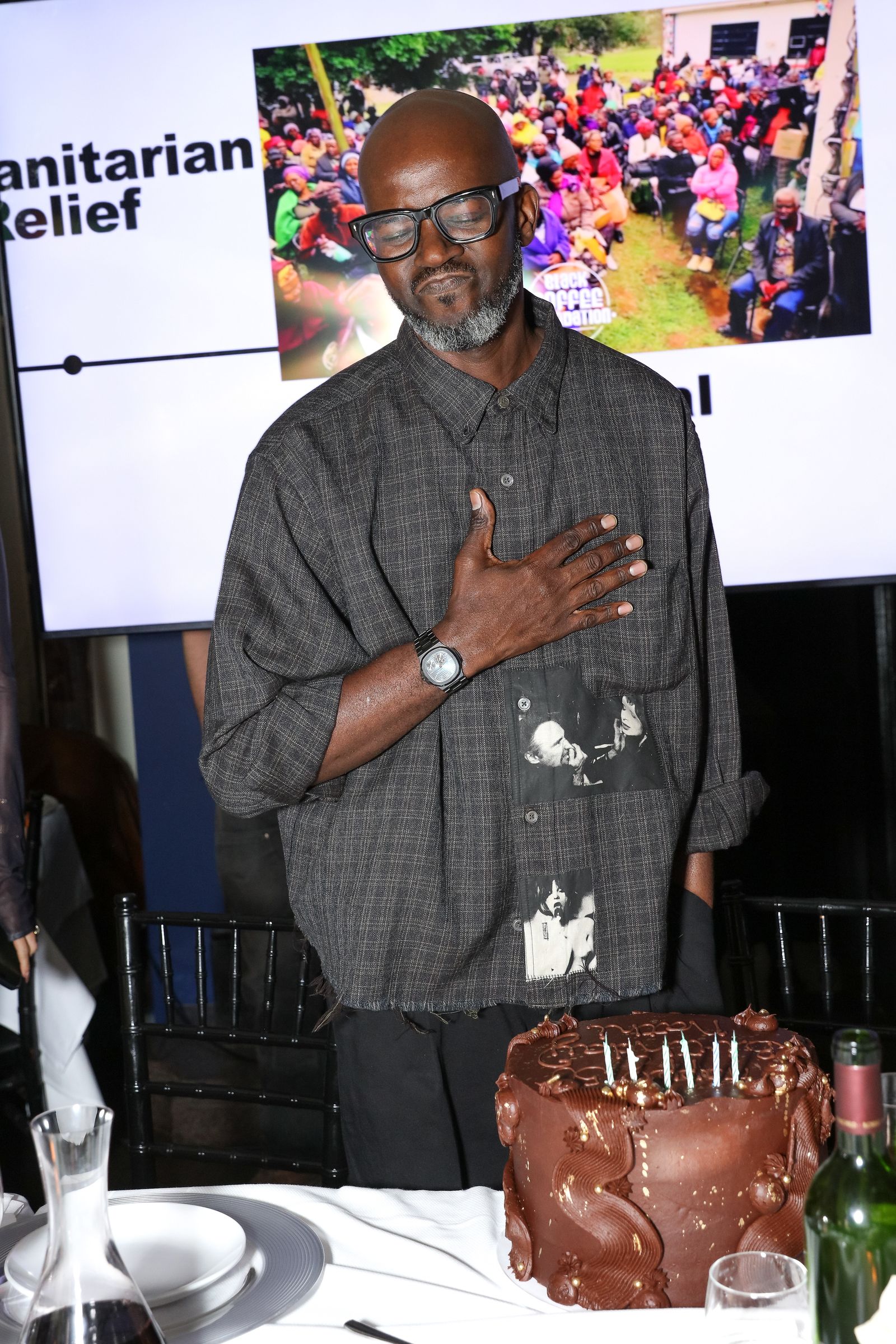 Picture may contain black coffee people adult watches chairs furniture birthday cake cakes cream and desserts