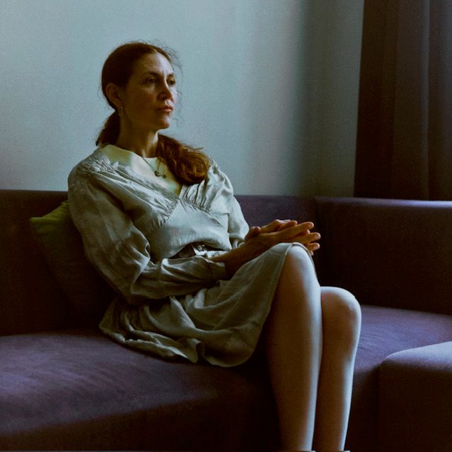 Image may show a person sitting on an adult sofa and furniture