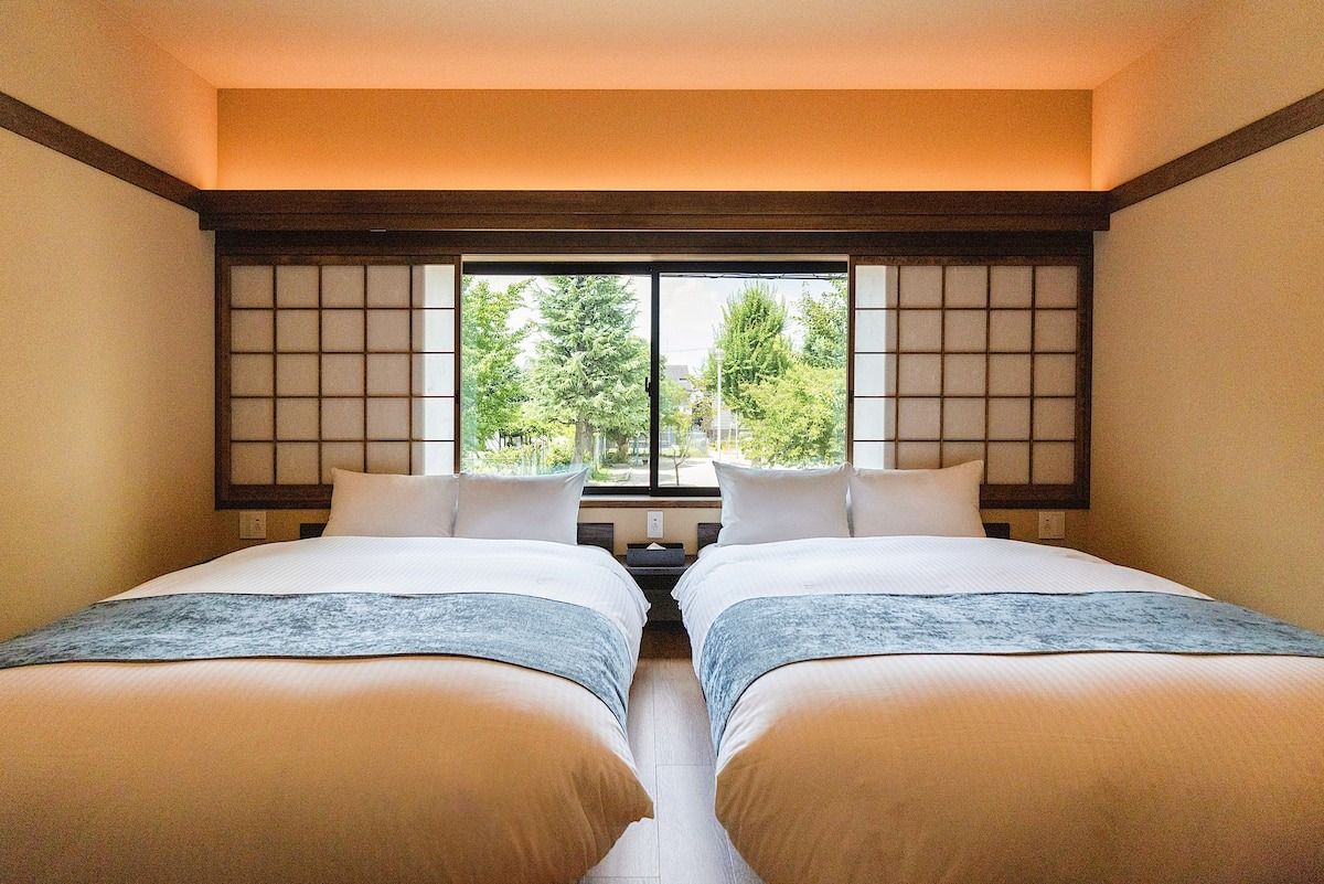 Image may contain furniture, bed, bedroom, interior interior design, windows, home decor and dormitory