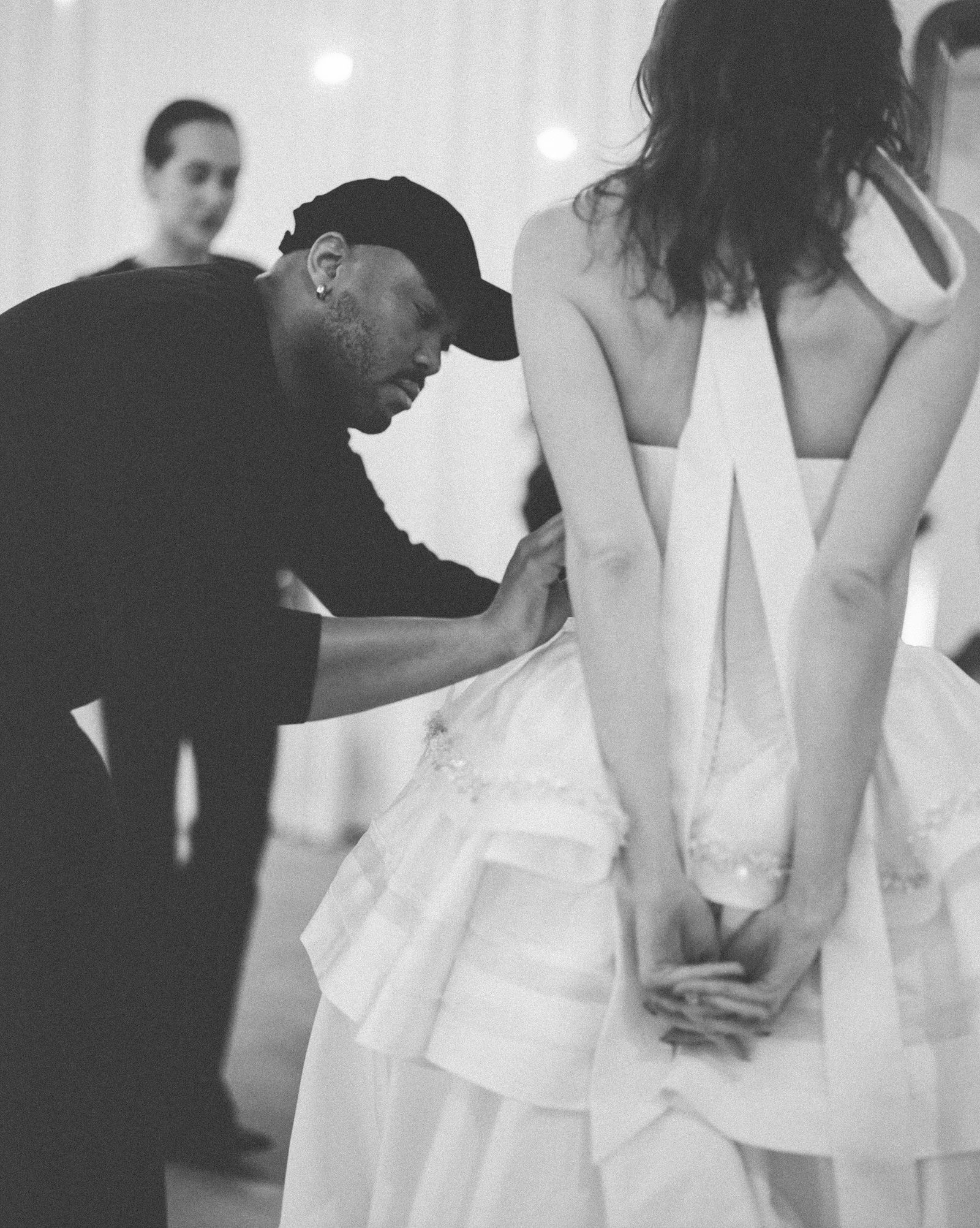 Image may contain clothing dress fashion formal dress suit wedding wedding dress adult face and head