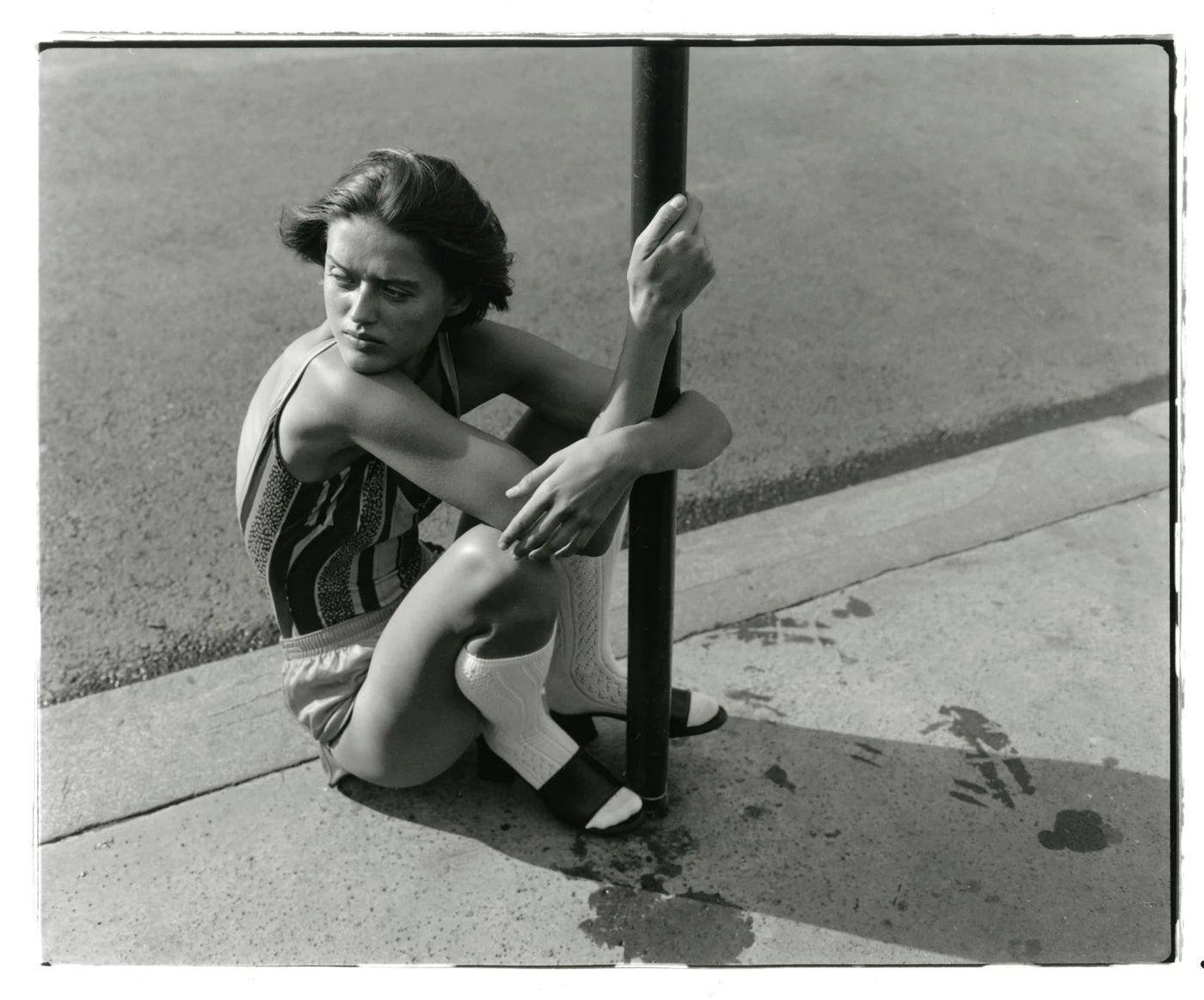 Image may contain clothing, shorts, face, head, people photography, portrait, body parts, fingers, hands, adults and sitting