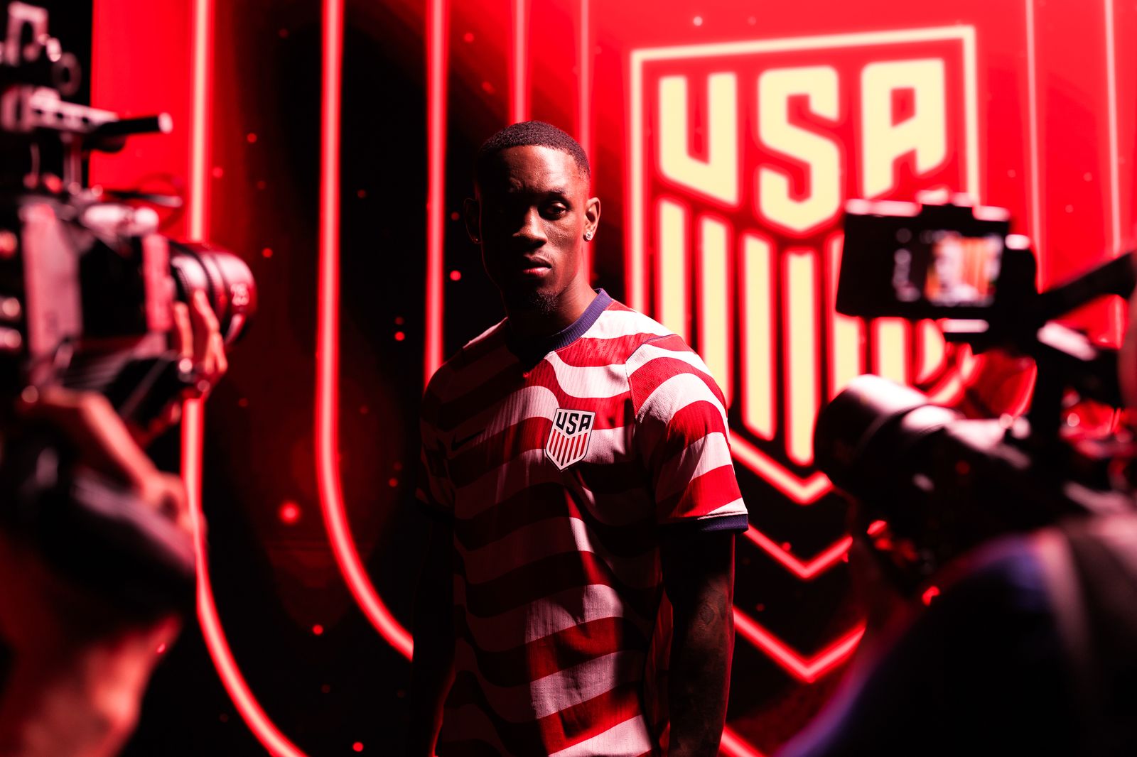 Image may contain adult faces, head photography, portraits, clothing, T-shirts, performers and solo performances