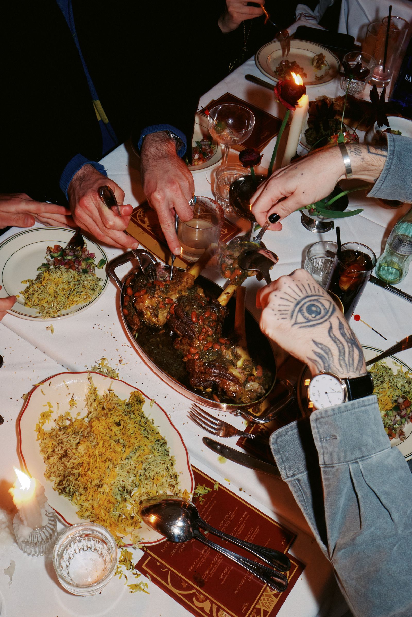 Image may contain food, food display, cutlery, meal, furniture, dining table, dinner, adult table and meat