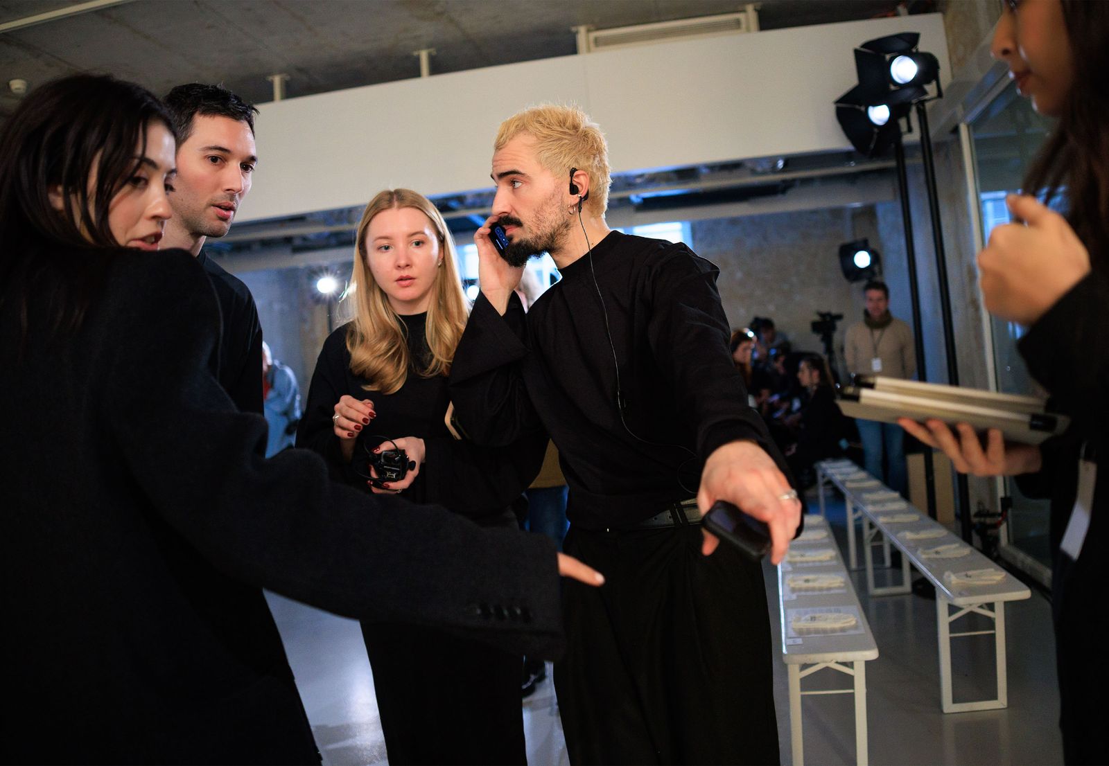 Image may contain adult photobombing, formal wear, clothing, suits, blonde hair, face, head and fashion