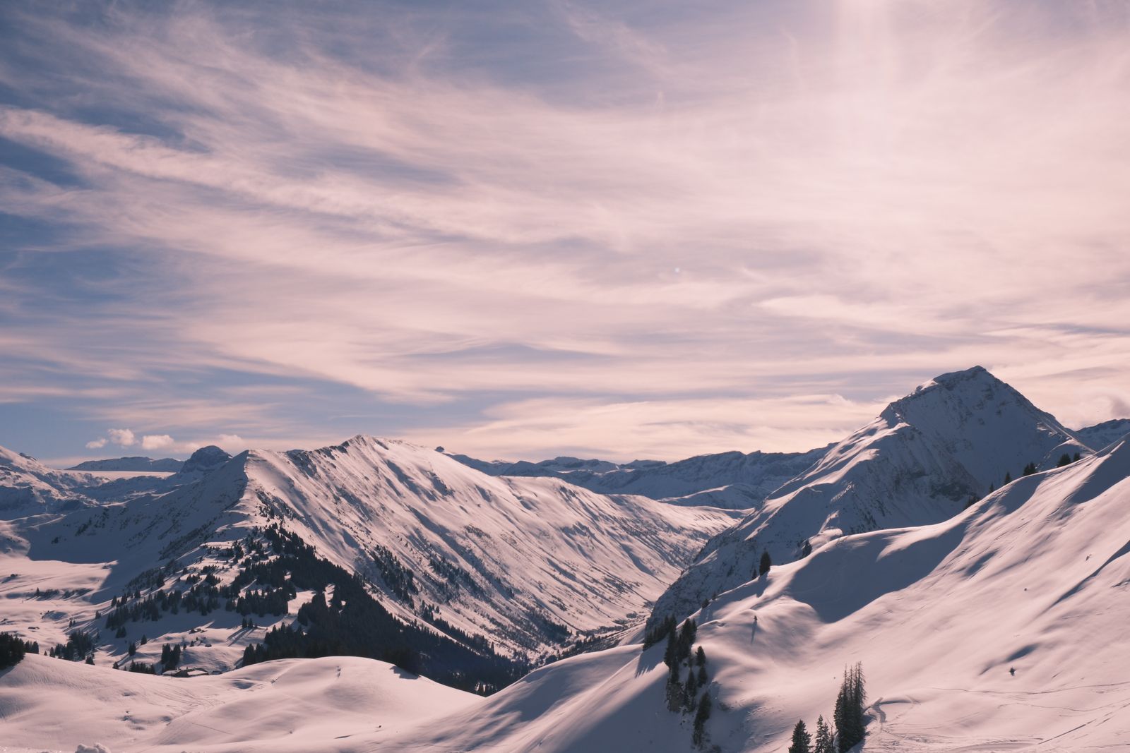 Image may contain mountains nature outdoor mountains mountain top scenery sky slopes and people