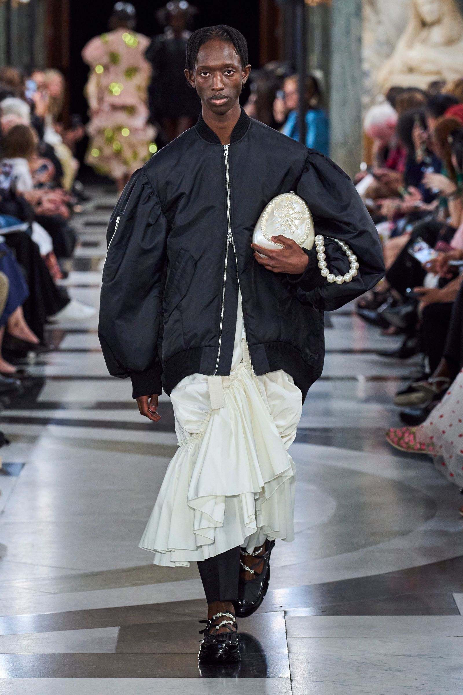 Image may contain clothing, clothing, people, jacket, coat, footwear, shoes, fashion crowd and skirt