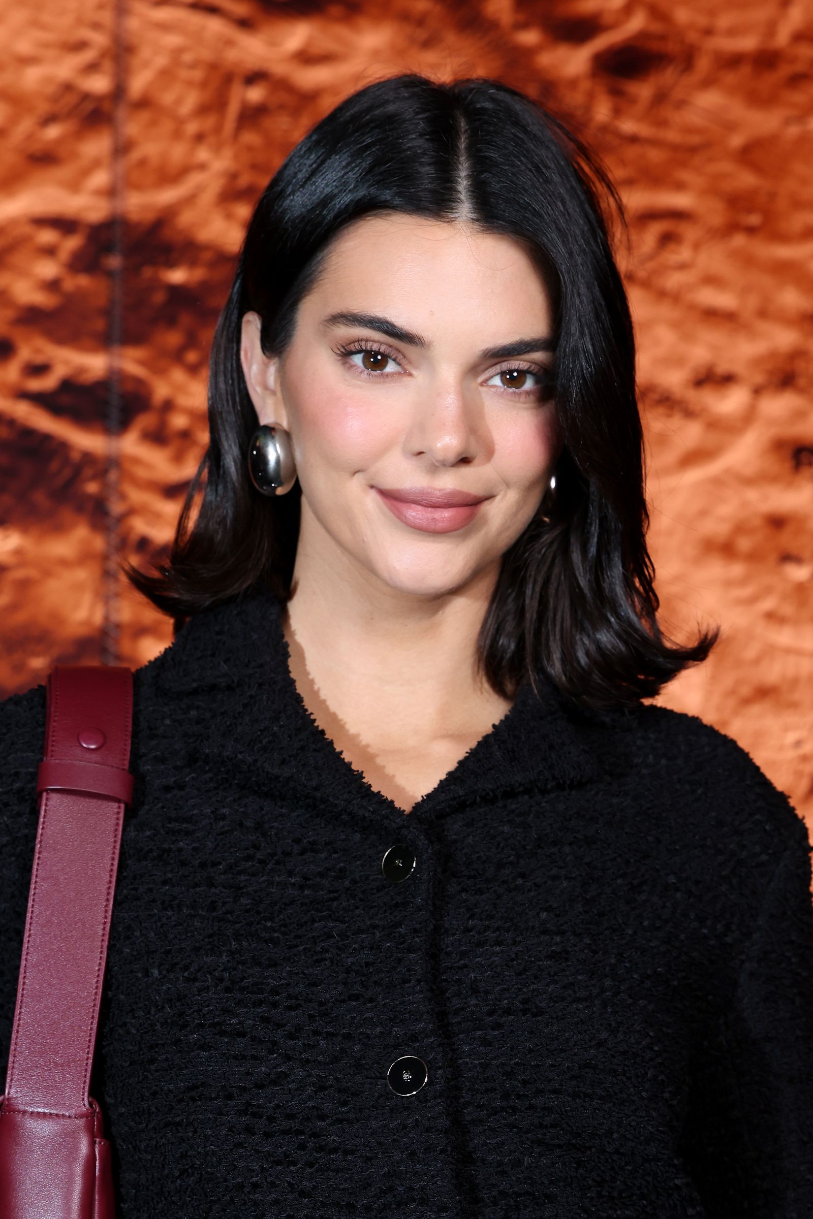 Image may contain Kendall Jenner adult face happy head smiling brunette hair accessories bag and handbag