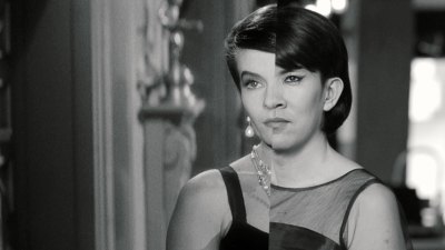 One movie still shows a split-screen shot of two people's faces merged into one. One is a woman from the original film and the other is an artist reenacting the film. 
