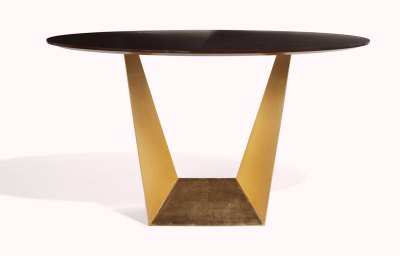 A table with a black top and gold geometric base.