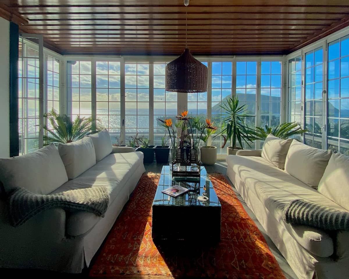 Image may contain home decor, sofa, furniture, plants, lamp, interior design, rug and architecture