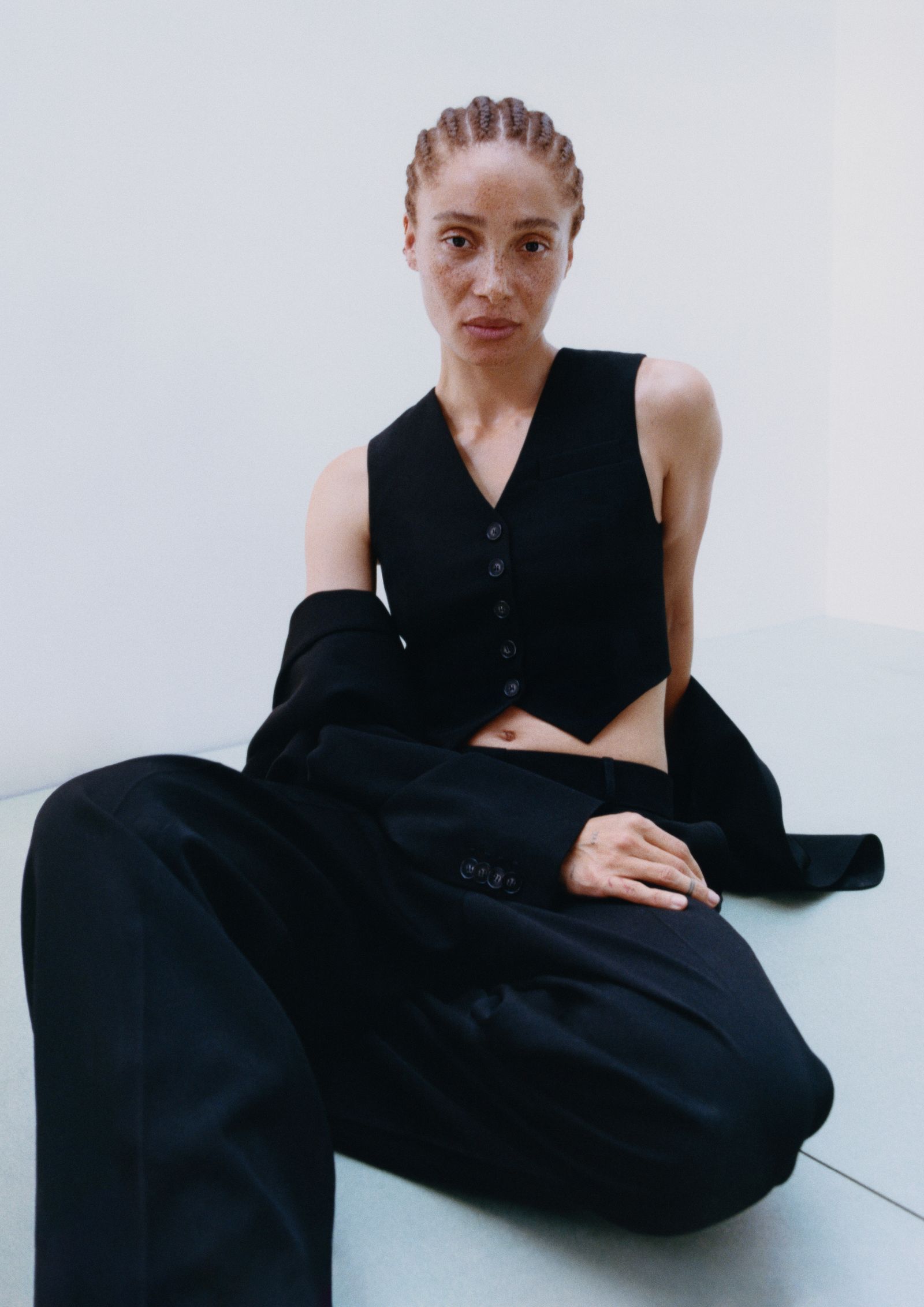 Image may contain seated person, adult clothing and vests