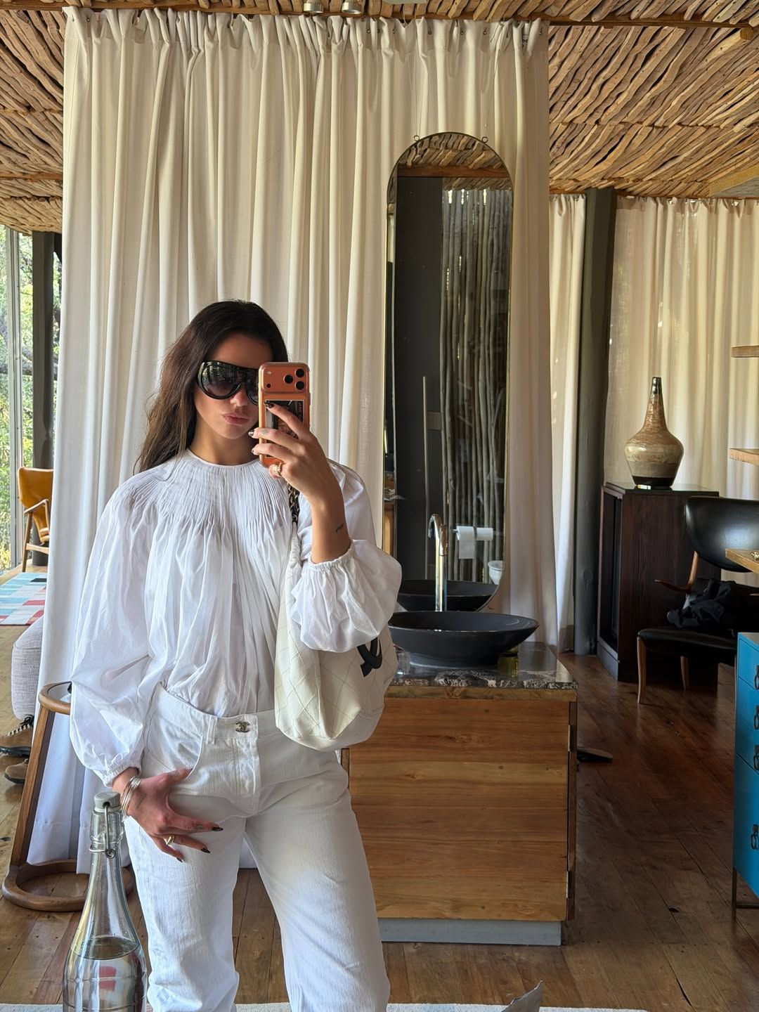 Image may contain clothing, sleeves, shirt, chair, furniture, adult, accessories, bag, handbag, head, face and sink