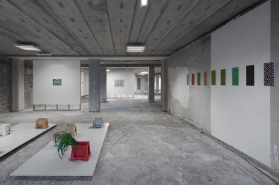 View of artwork displayed in unfinished office building.