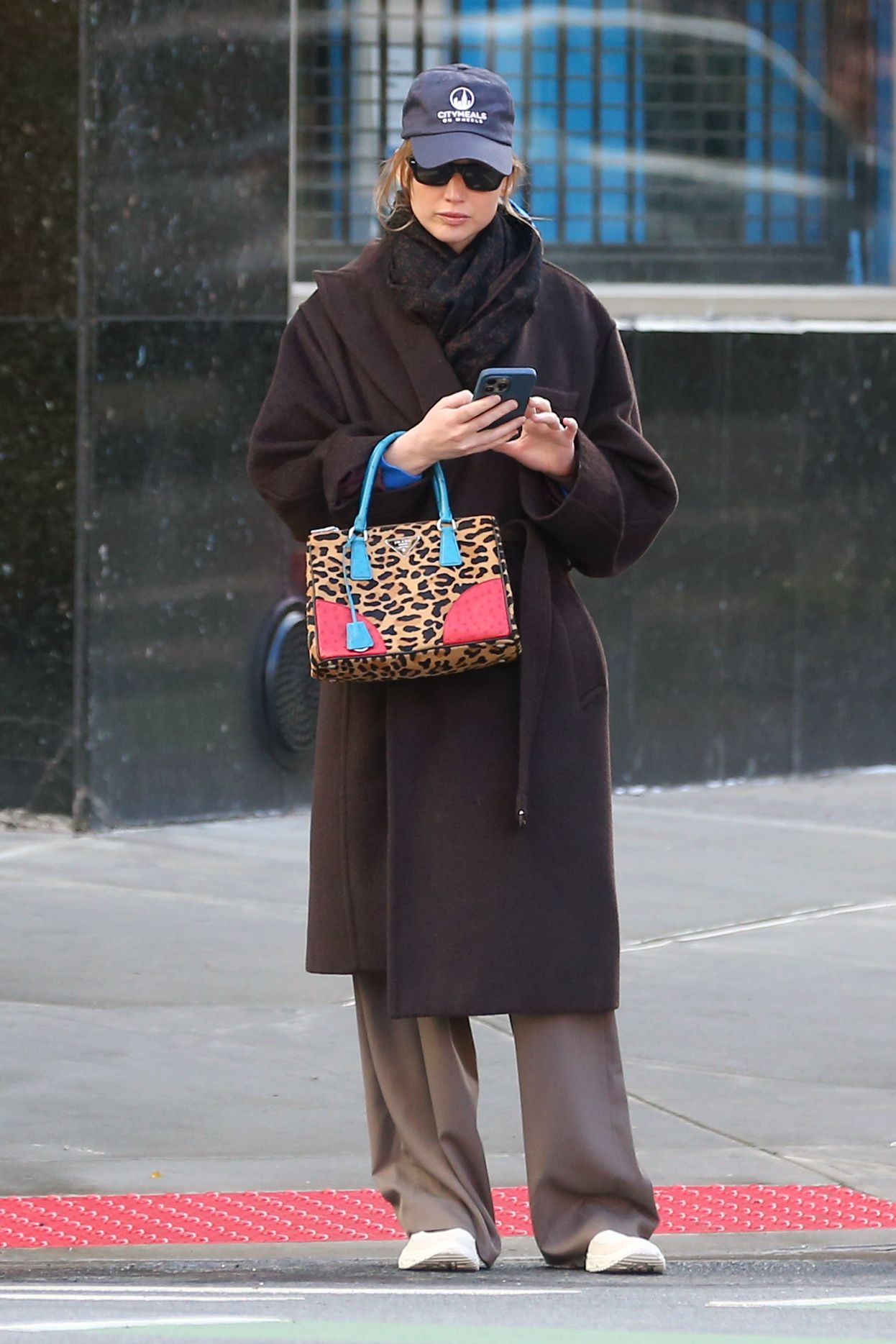 Image may contain Jennifer Lawrence accessories bags handbags wallets clothing outerwear men baseball caps hats and hats