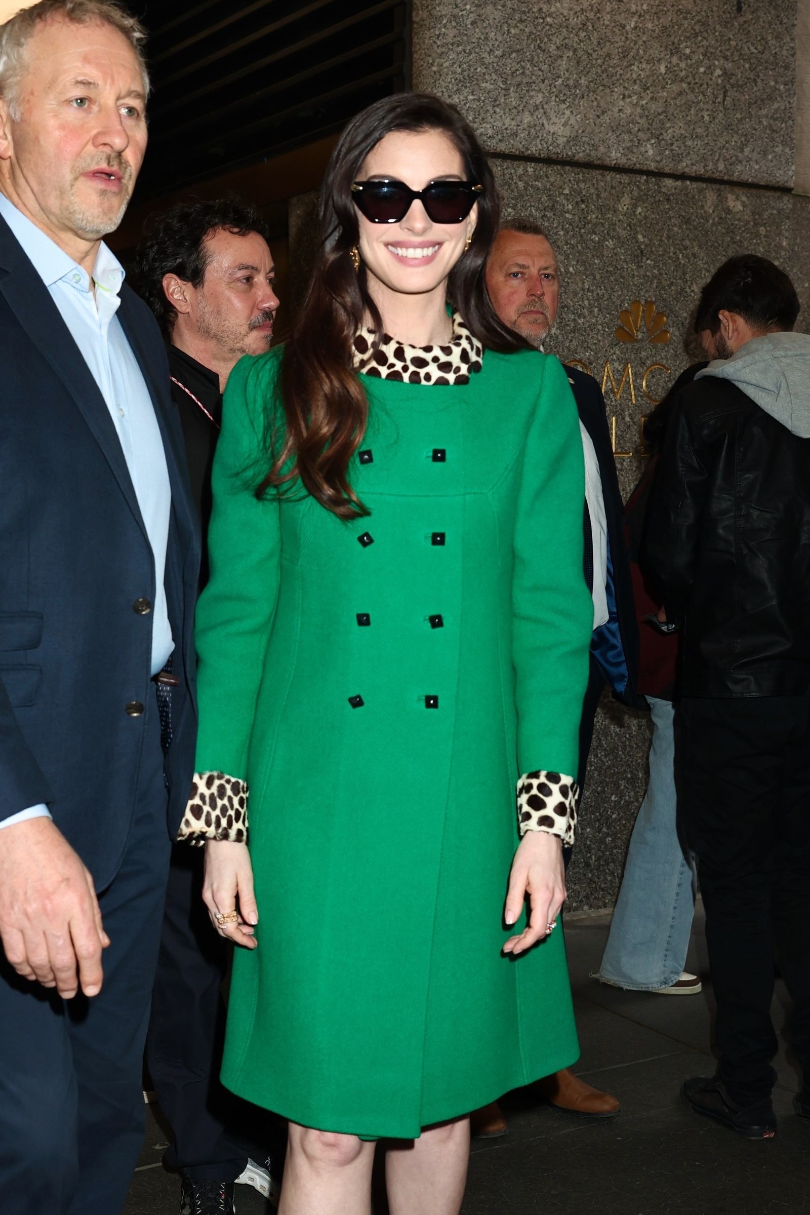 Image may contain Anne Hathaway Jorge Furtado Clothing Coats Men Adult Accessories Glasses Coats and Jeans