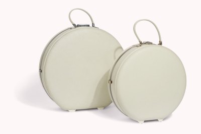 Two cream hat box suitcases.