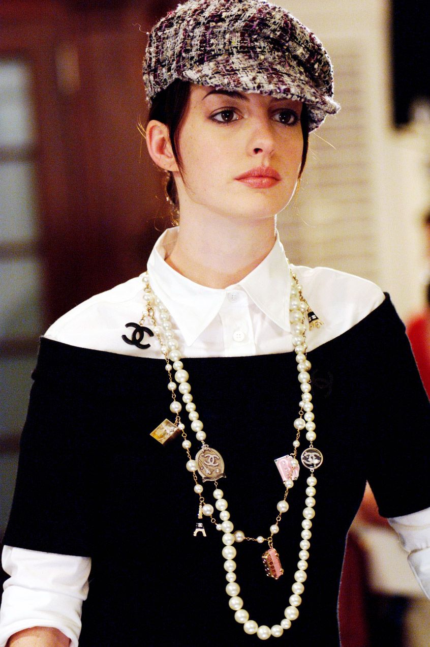 Image may contain Anne Hathaway accessories, people, jewelry, necklaces, hats, clothing, hats, face, head and pendants