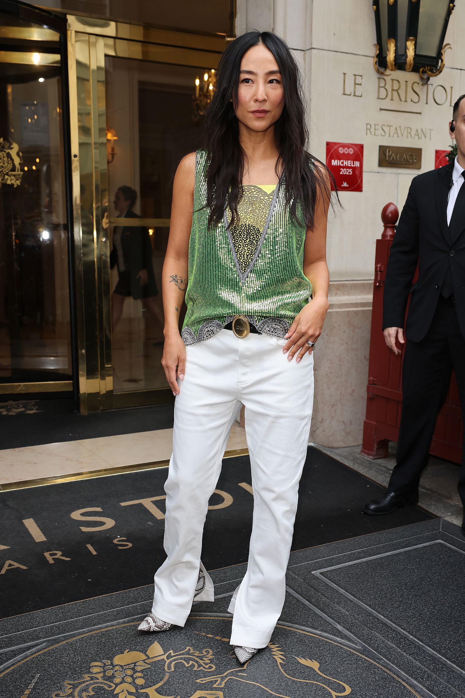 Image may contain Greta Lee clothing, pants, standing, brunette, hair and adult