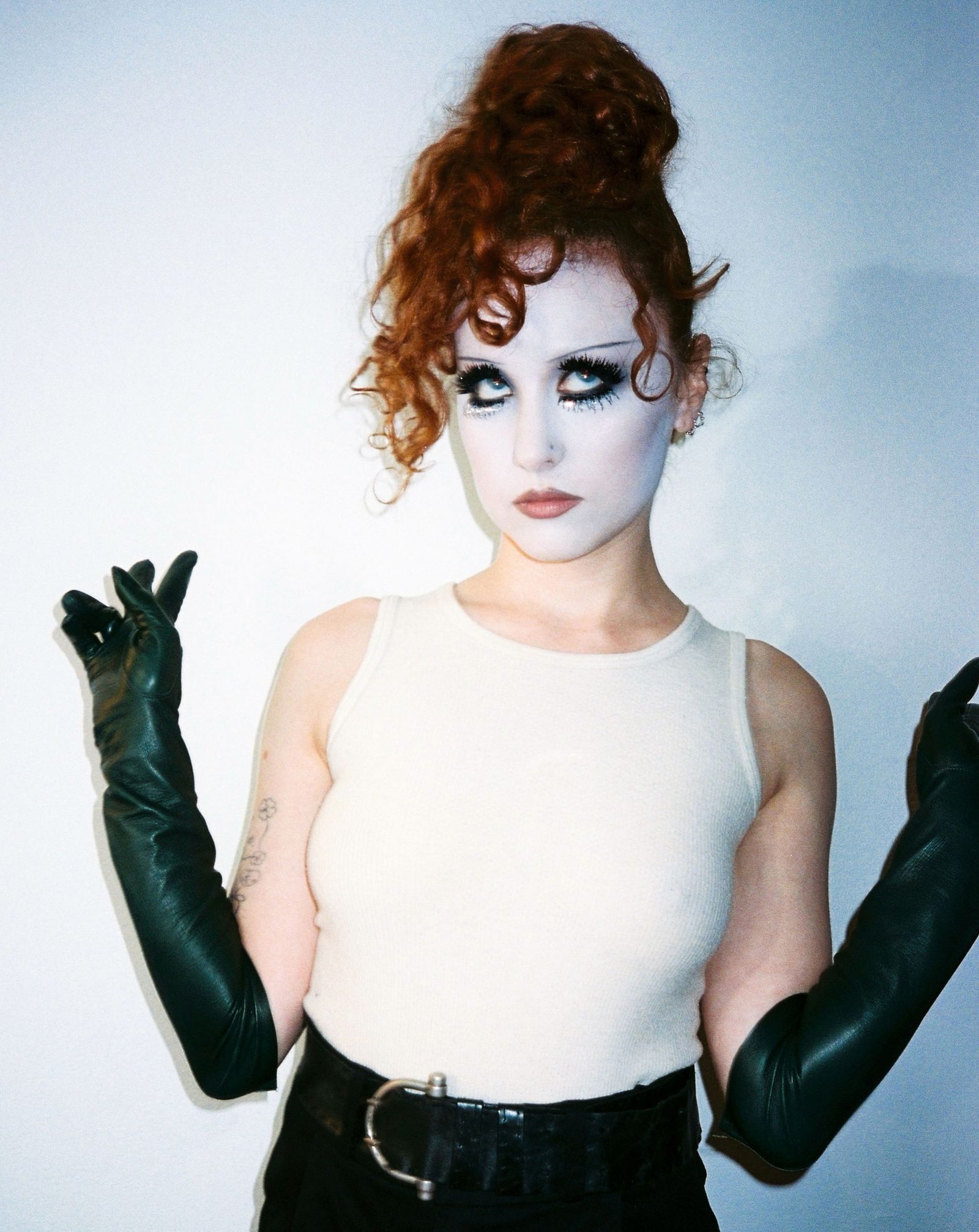 Images may contain clothing, gloves, faces, heads, people photography, portraits, adult clothing and vests