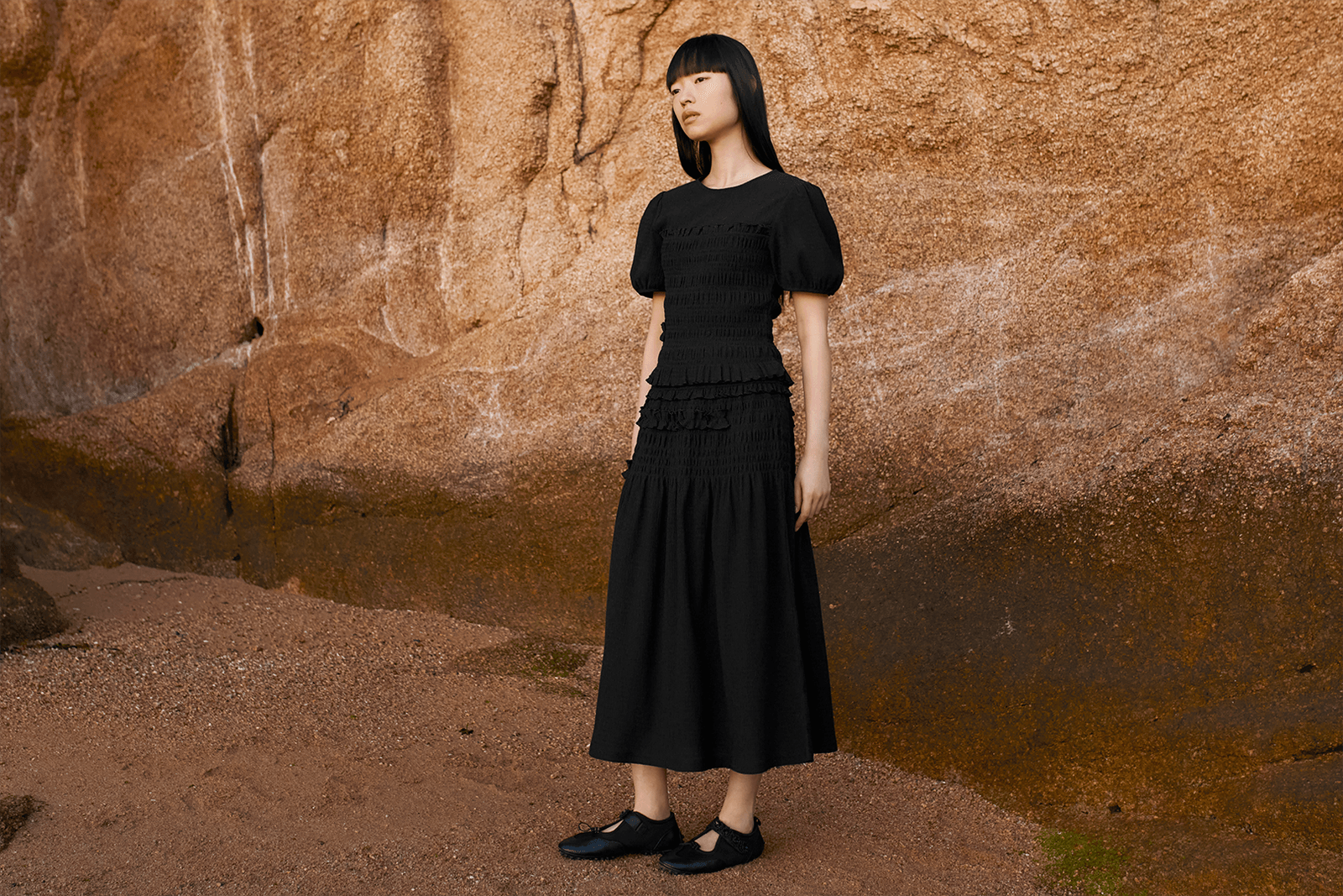 Image may contain clothing, dress, evening gown, formal wear, adult sleeves, standing face, head and footwear