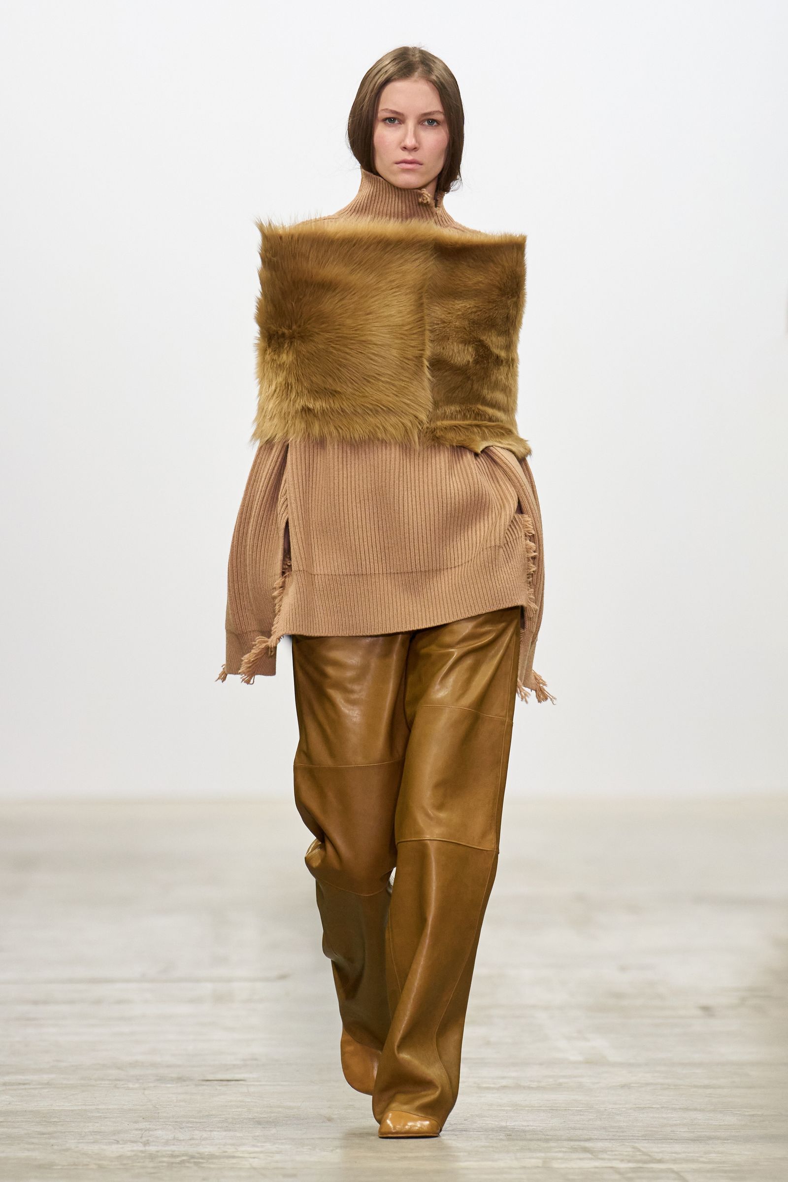 Image may contain adult clothing, outerwear, furs and fashion