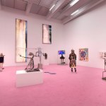 Gallery with sculptures on pink carpet.