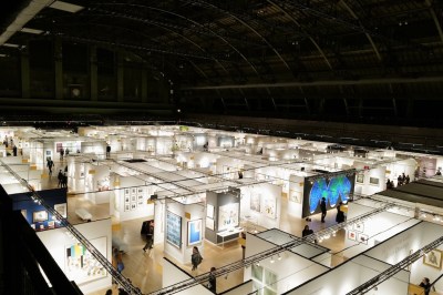 Aerial view of an art fair with prints hanging on multiple booths.