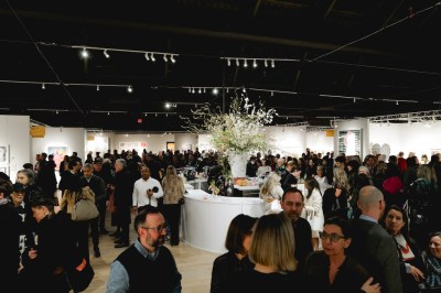A crowd gathered in the clearing of the art fair.