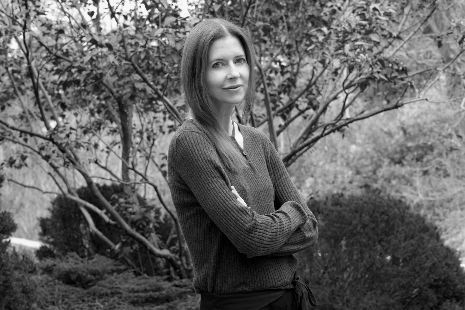 Image may contain clothing, knitwear, sweaters, faces, heads, people photography, happy smiling adults and plants