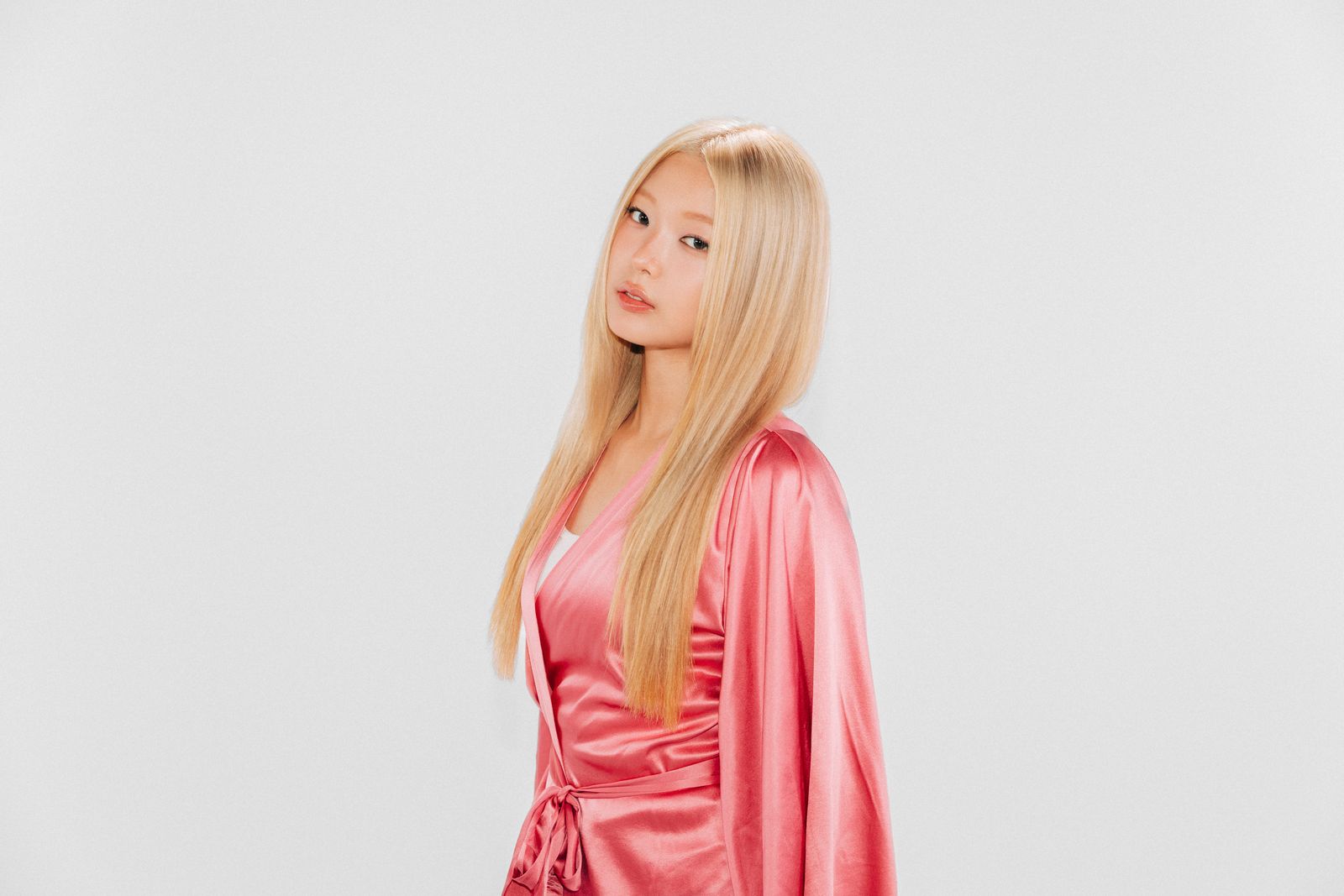 Image may contain blonde people, adults, faces, heads, photography, portraits, clothing, formal wear and fashion