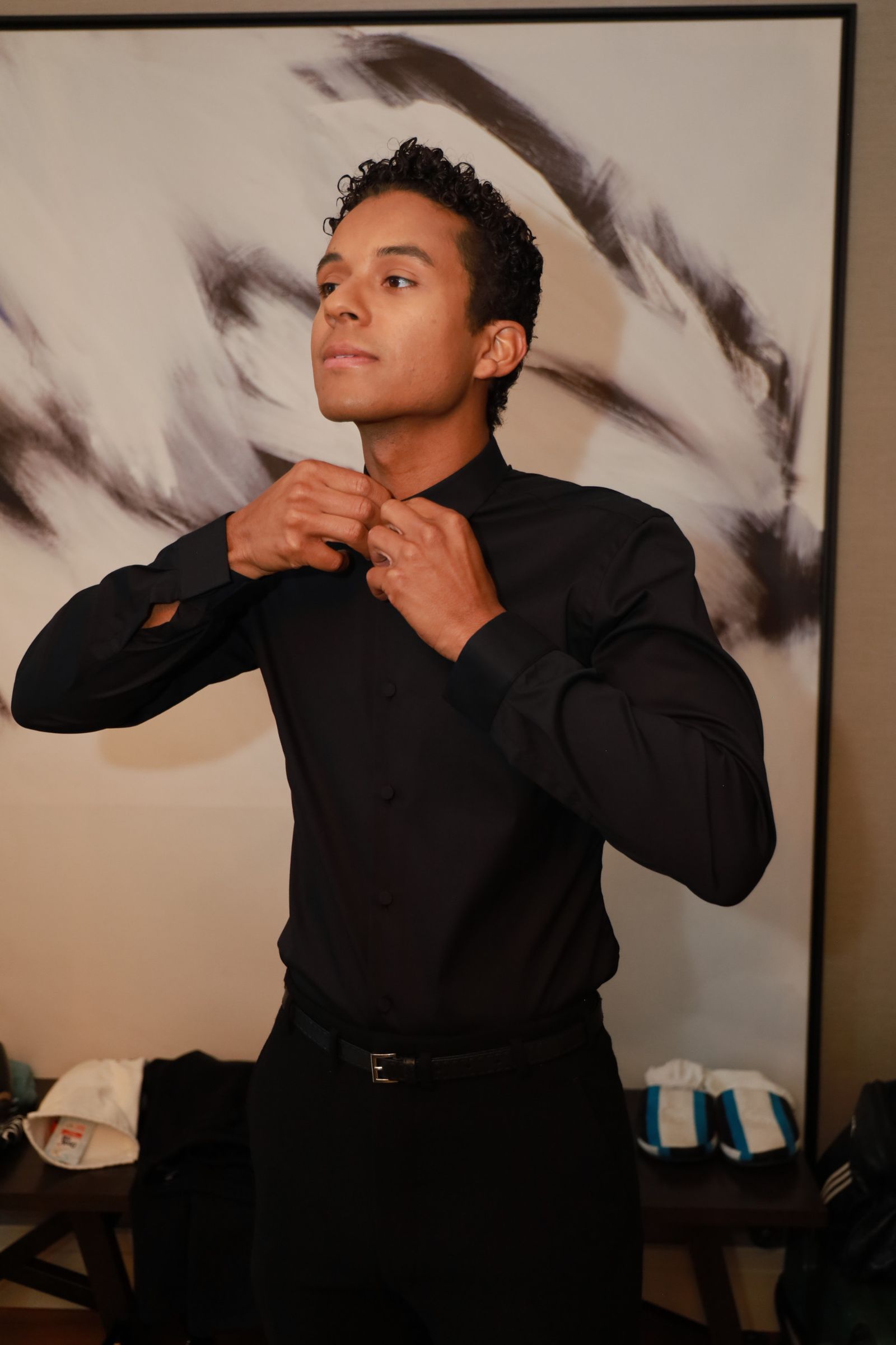 Image may contain face, head, people photography, portrait, black hair, hair, adult clothing, shirts and sleeves