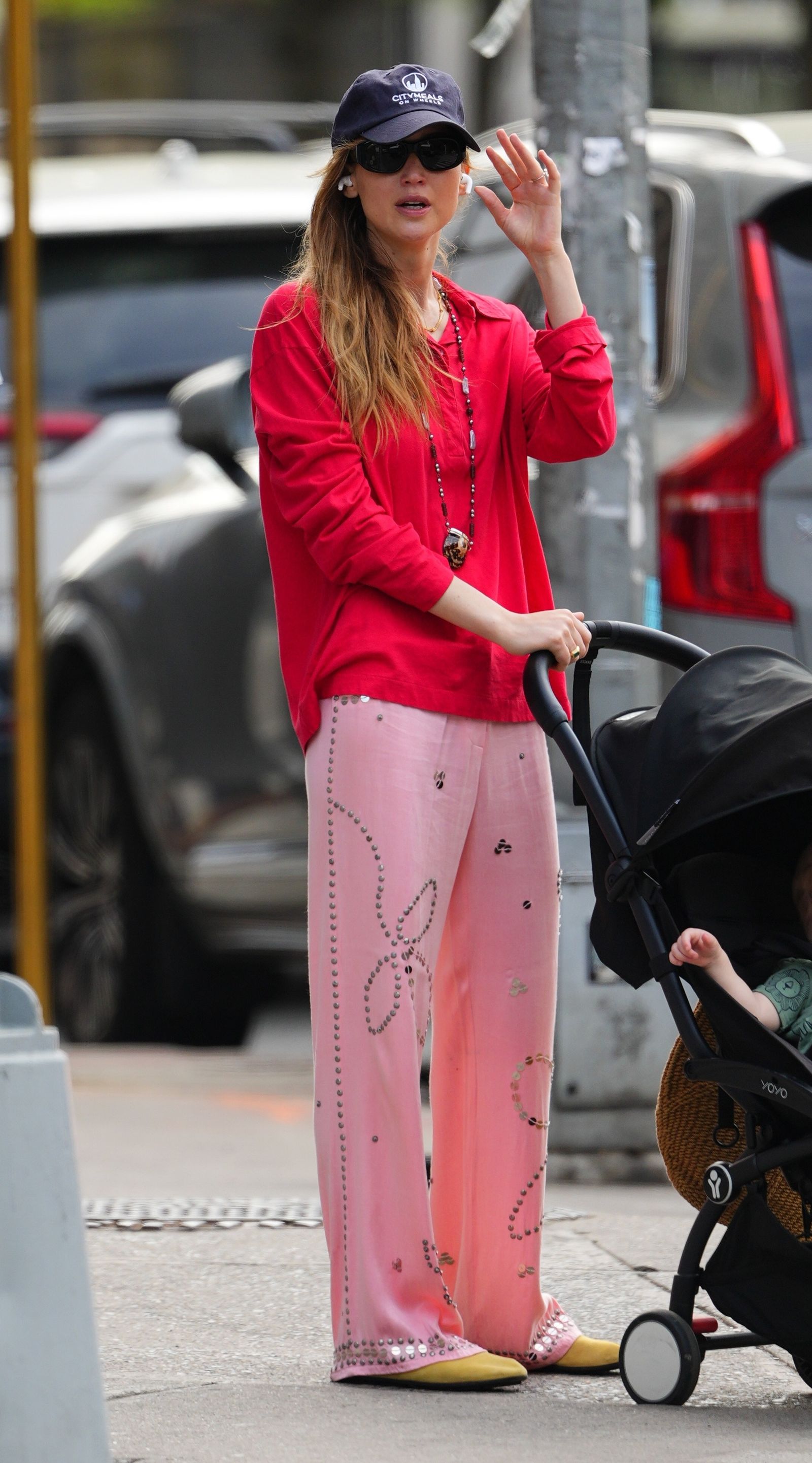 New York actress Jennifer Lawrence lit up the streets of New York as she strolled with her kids in a red button-down shirt…